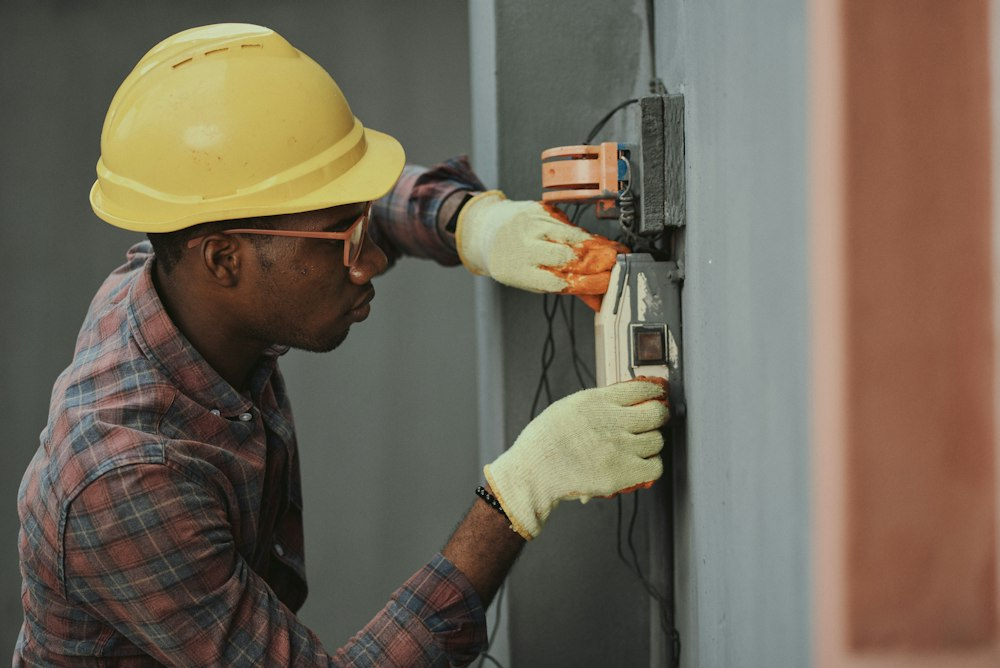 A worker is setting up the HVAC system at a residence.