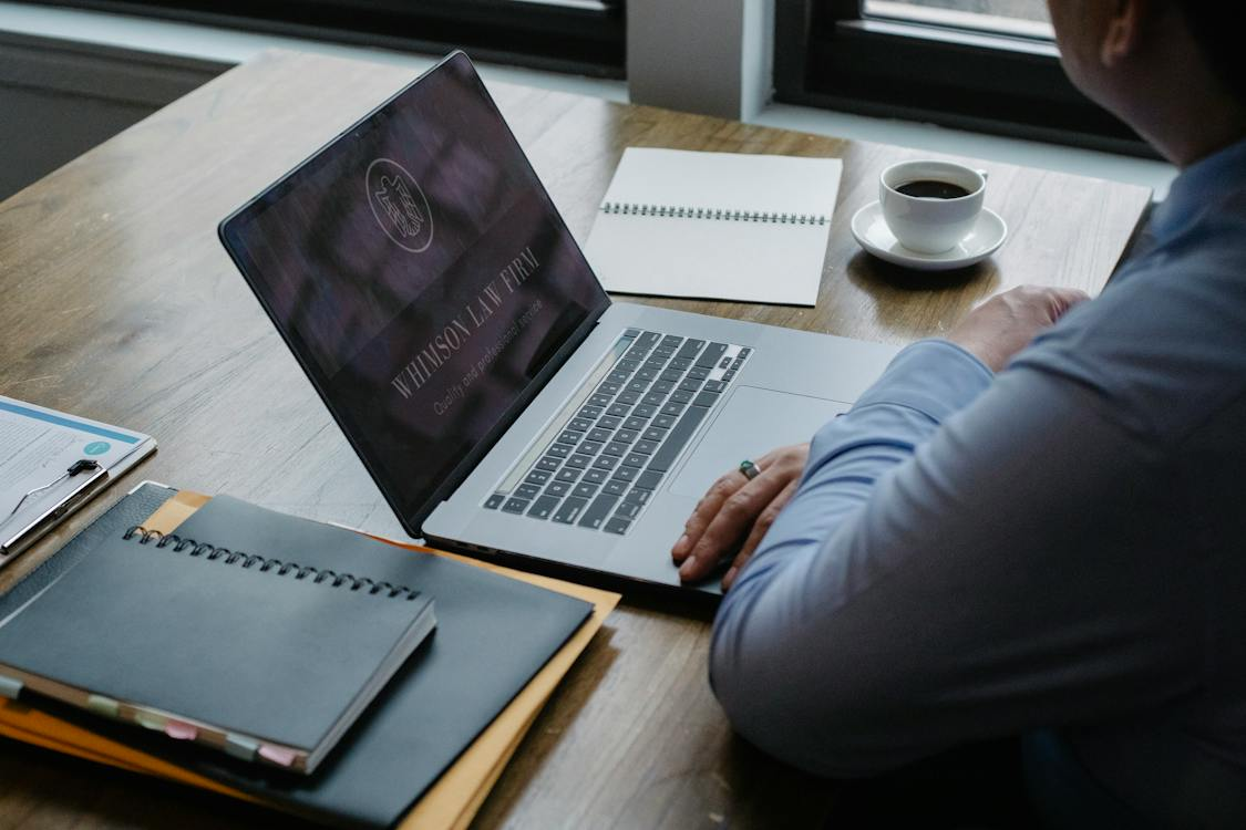 A lawyer is doing research on his laptop.