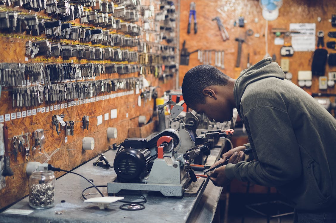 Locksmith is at his workplace working on a project.